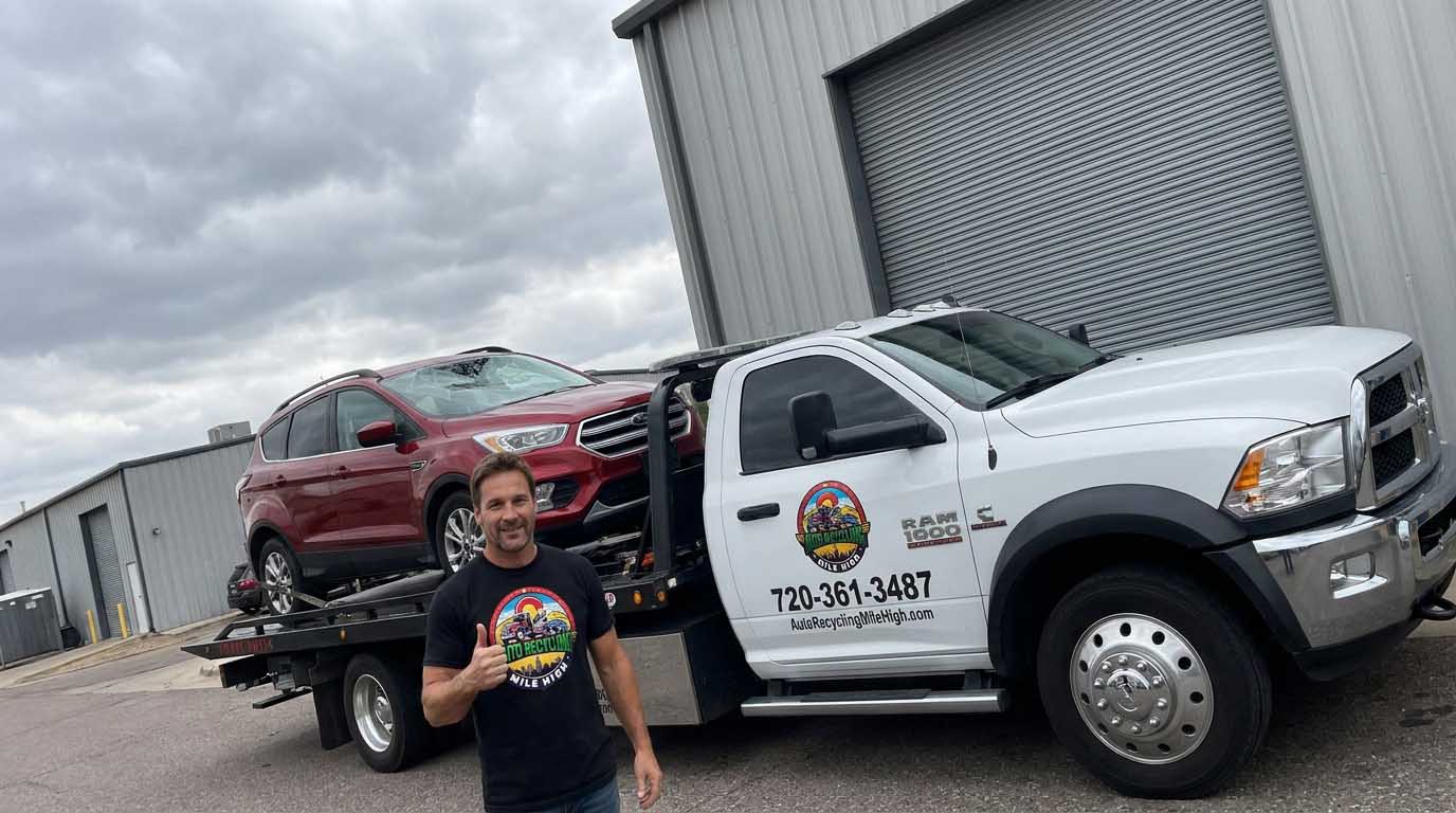 2017 Ford Escape loaded on an Auto Recycling Mile High tow truck at a cash-for-cars pickup in the Denver metro
