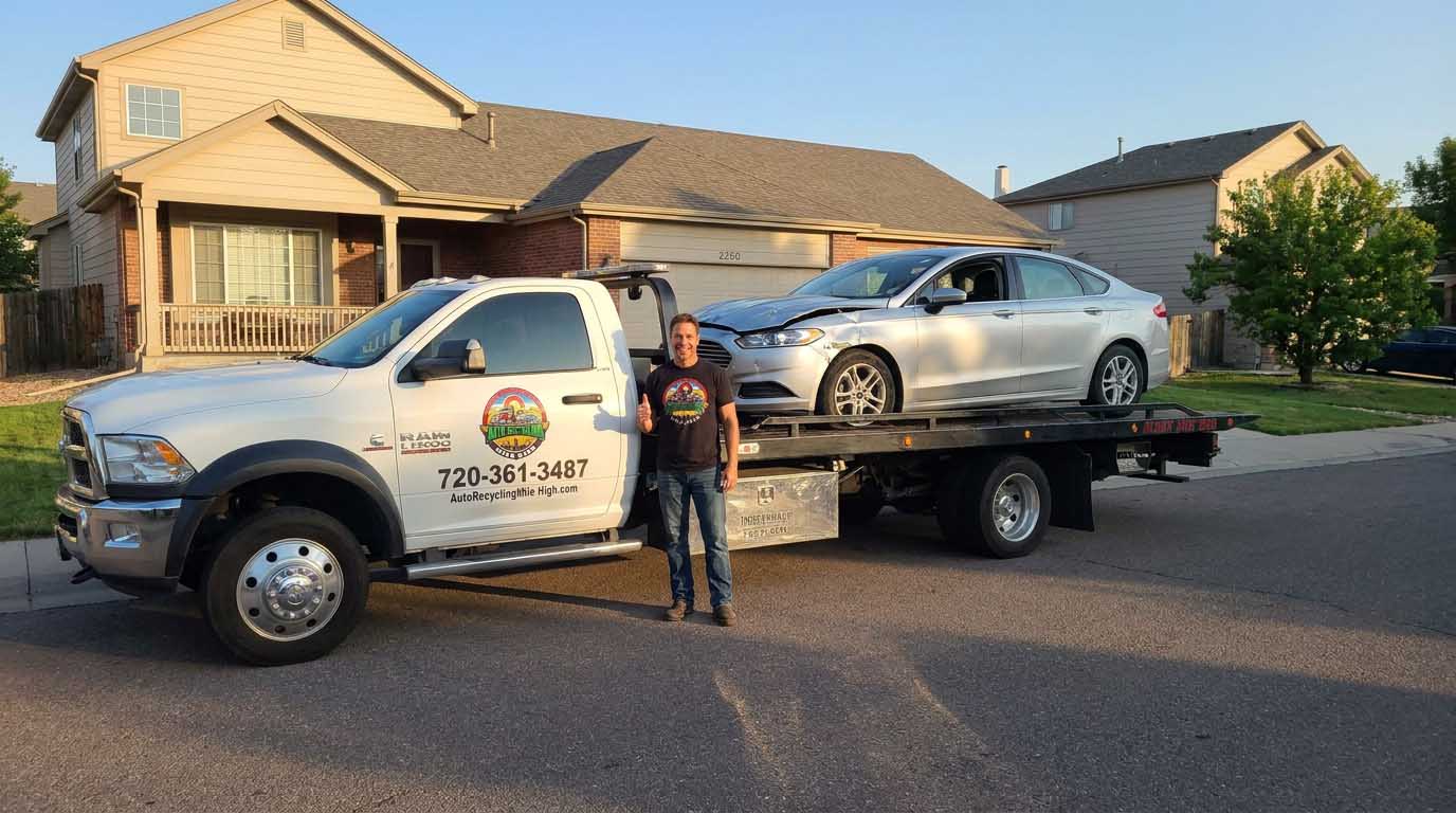 2017 Ford Fusion loaded on an Auto Recycling Mile High tow truck at a cash-for-cars pickup in the Denver metro