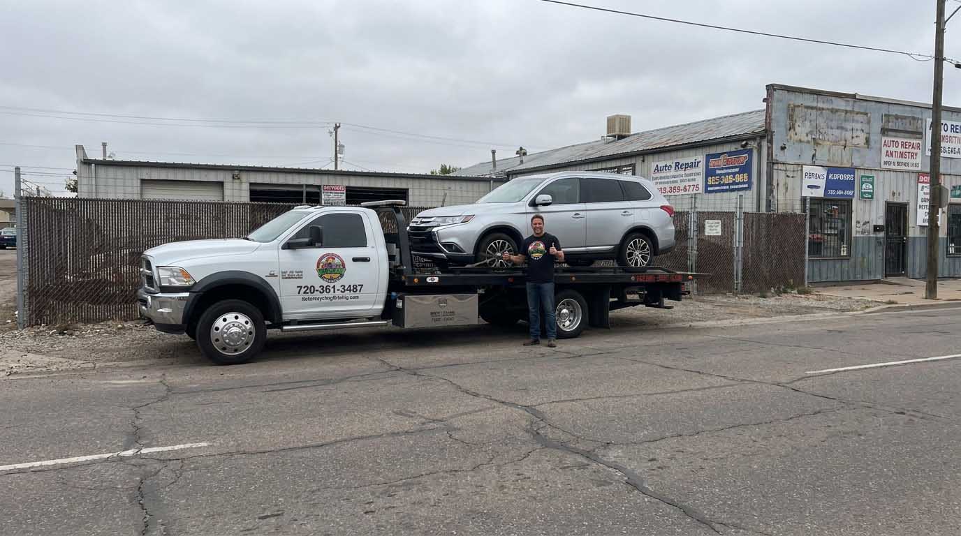 2017 Mitsubishi Outlander loaded on an Auto Recycling Mile High tow truck at a cash-for-cars pickup in the Denver metro