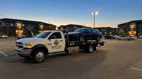 Black 2025 Honda Accord on an Auto Recycling Mile High flatbed tow truck during a cash-for-cars pickup in Broomfield, Colorado
